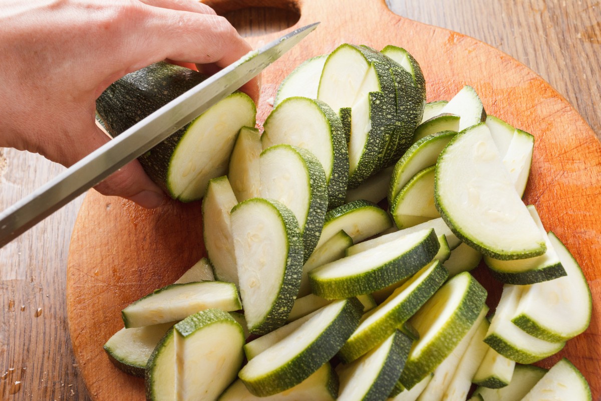 Cut zucchini on chopping board for cooking